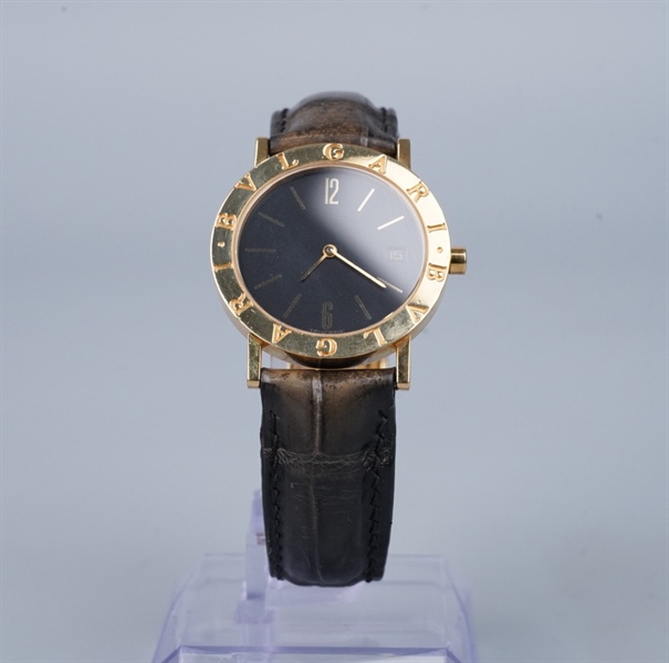 Đồng hồ Bvlgari mặt tròn viền vàng dây đen (95462) KG+